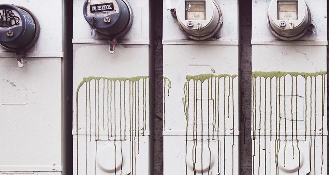 Old energy meters on side of building